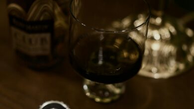 Autoschlüssel neben einer Flasche und einem Glas auf einem Tisch